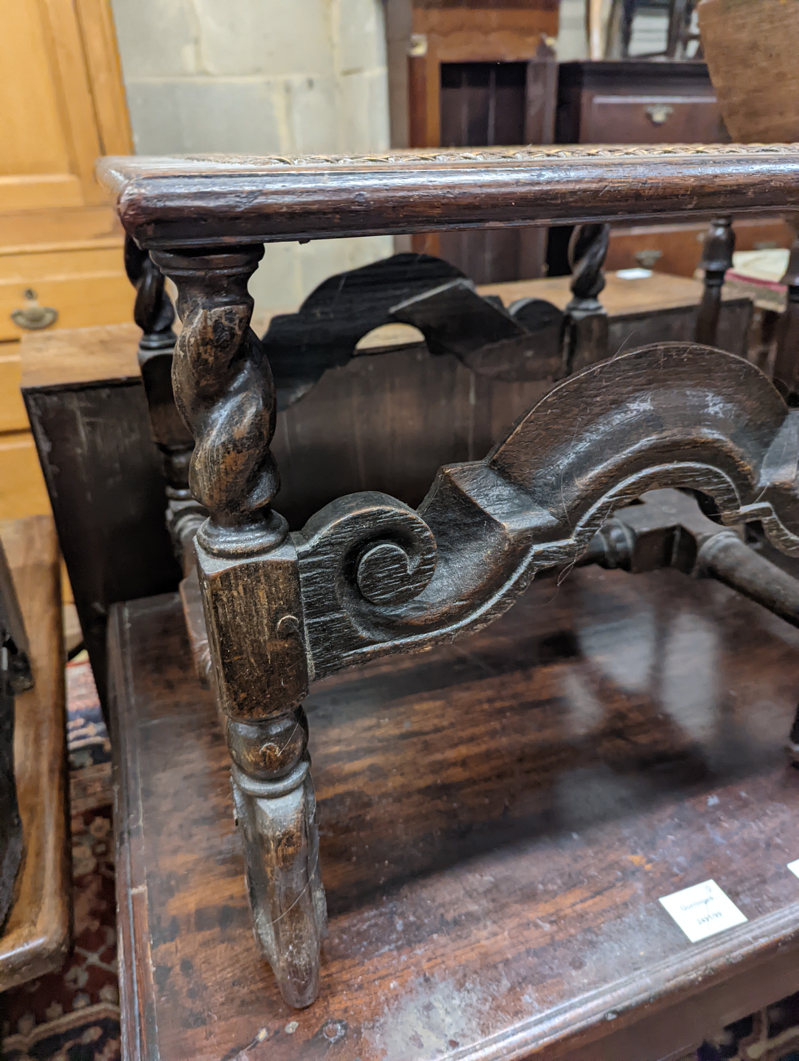 A 17th century style carved oak stool, with caned seat and H stretcher, width 47cm, depth 46cm, height 42cm